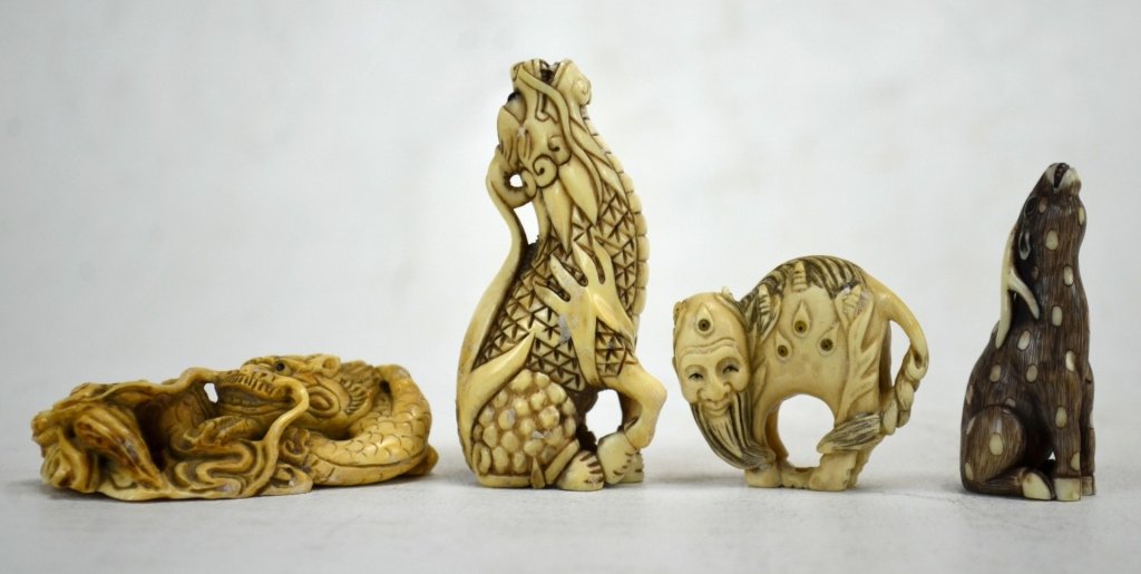 Four Antique Ivory Mystical Creature Netsukes: Four Japanese antique ivory netsukes; one a dragon, the second a kyrin, the third a man with an animal body, and the last a celestial deer. All marked. 19th century. Dimensions: Biggest height - 2 5/8