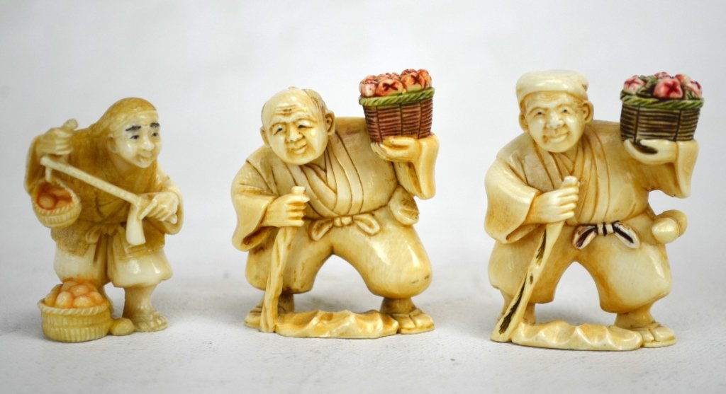 Three Antique Ivory Netsukes of Fruit Vendors: Three Japanese antique ivory netsukes of men selling fruit. All marked. 19th century. Dimensions: Biggest height - 2" Smallest height - 1 3/4"