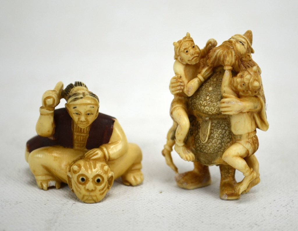 Two Japanese Antique Ivory Netsukes of Men and Oni: Two antique ivory netsukes; one with a man beating an oni, the other a samurai holding two onis. Both marked. 19th century. Dimensions: Biggest height - 2" Smallest height - 1 1/8" length - 1 3/4"