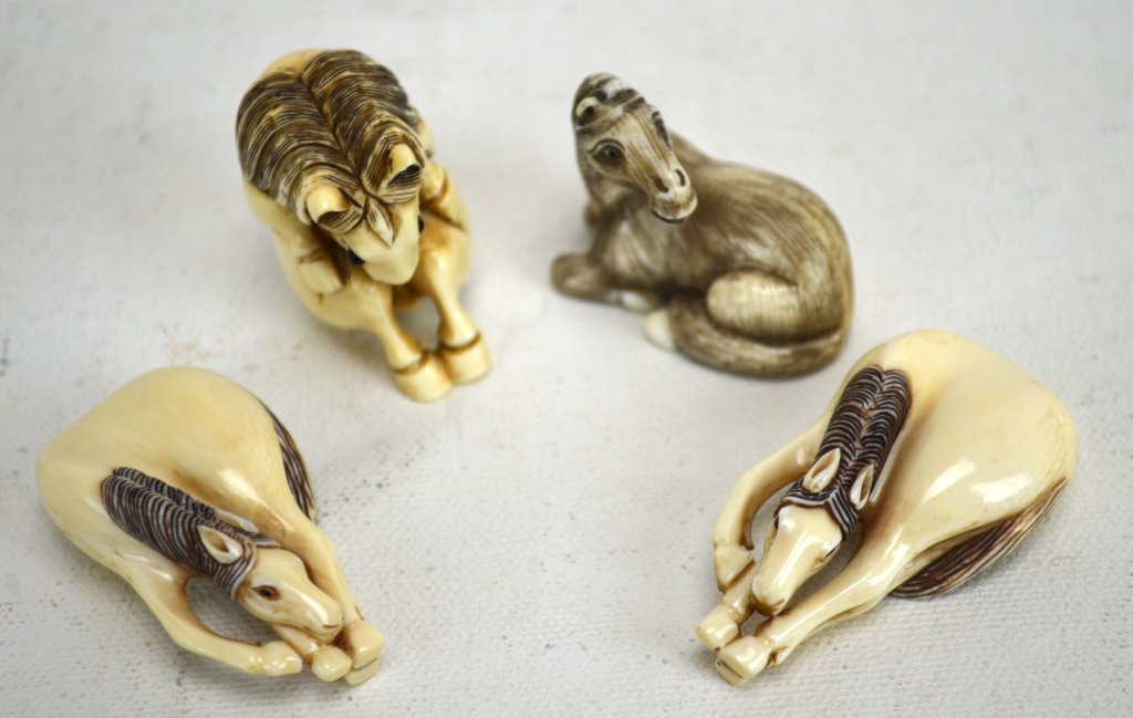 Four Japanese Antique Ivory Netsukes of Horses: Four antique ivory netsukes of horses; a curled horse, two playing horses, and a seated horse. All marked. 19th century. Dimensions: Biggest height - 1 3/8" Smallest height - 3/8"