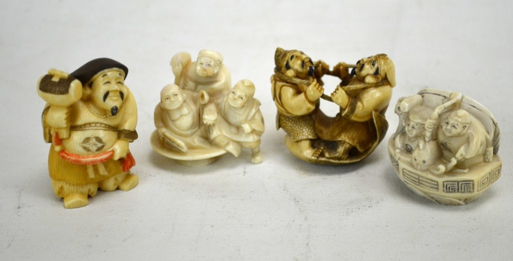 Four Antique Ivory Netsukes of Japanese Figures: Four antique ivory netsukes of Japanese figures; one of Ebisu & Diako playing, another of Buddha, Diako & Ebisu seated in a cup, another of Diako and Ebisu in a boat, and one more of a polychrome Diak