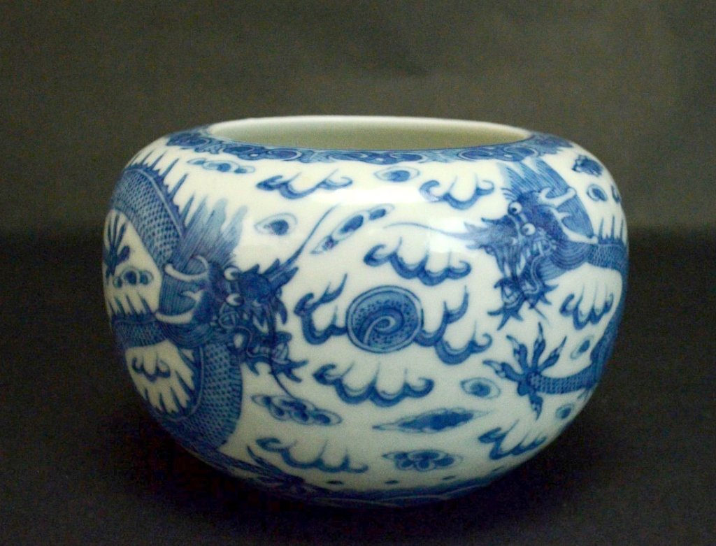 Chinese Blue and White Porcelain Brush Washer: A Chinese blue and white porcelain bowl with design of two dragons amidst the clouds chasing a pearl. Diameter - 5 1/4" Height - 3 1/2"