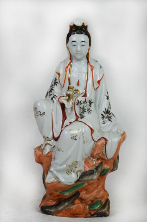 Chinese Seated Guan Yin Statue: Chinese porcelain statue of a seated Guan Yin with copper red and gilt accents. Height - 12 1/2" Width 5 1/2" 19/20th Century Property from Dr Ronald Wayne. Tampa, FL