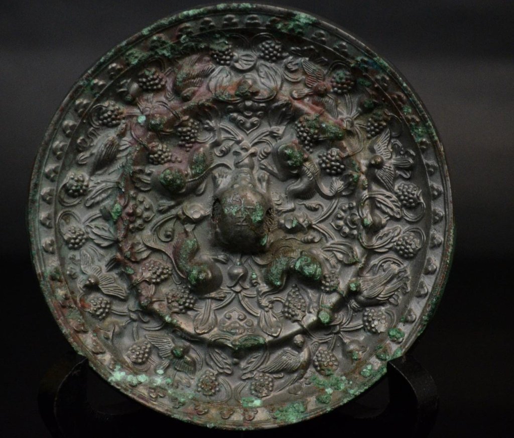 Chinese Bronze Carved Mirror: Chinese bronze mirror carved with birds, grapes and animals. size: 4 1/4" x3/8" Possible Han Dynasty
