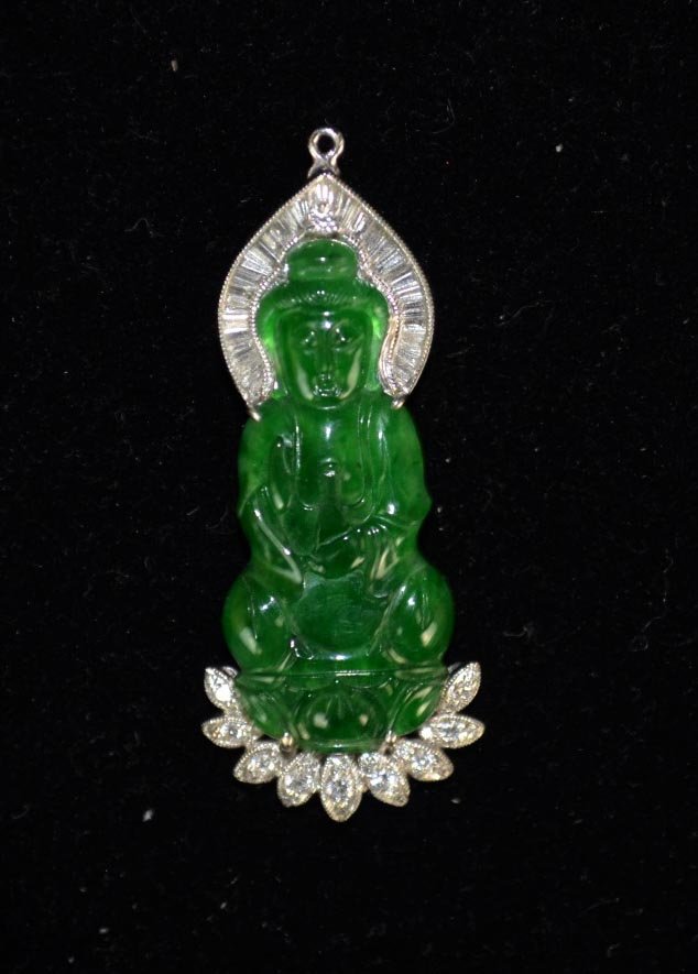 Natural Carved chinese Green Jadeite Pendant of Guanyin: Natural chinese green jadeite pendant carved with seated Guanyin, the 18k white gold setting accented with diamonds. Guaranteed Type "A".has the "GIA" Certificate Jadeite: 35mm x 15mm x 3mm. Overall: