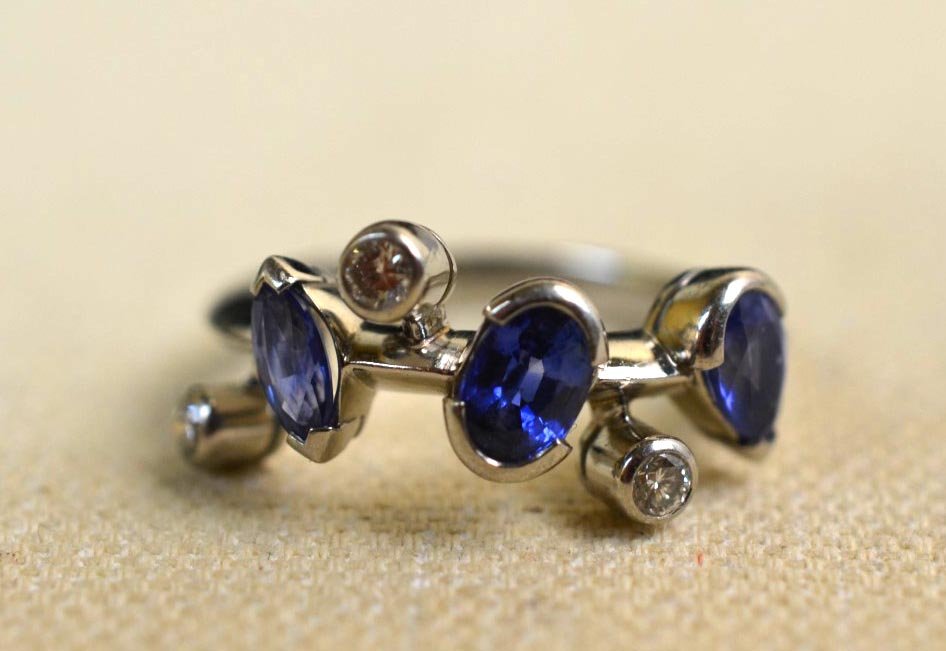 Cartier Diamond, Sapphire, & 18k White Gold Ring: Cartier ladies ring with oval and two pear-cut sapphires, and three round diamonds, set in 18k white gold. Engraved Cartier with serial number, 750. Size 6. weight: 8.8g