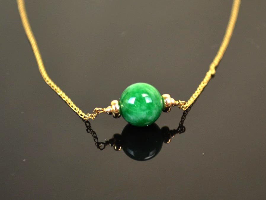 14K Yellow Gold Necklace with Jadeite Pendant: Necklace with natural colored green jadeite ball pendant, suspended from a 14k yellow gold chain Weight; 2.7g