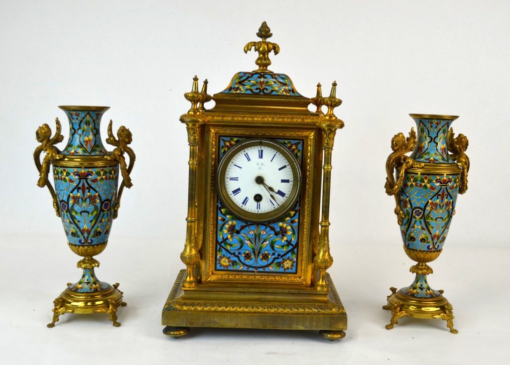 Three Piece Enameled Bronze Clock & Vase Set: European Style bronze set with enameled floral design on blue ground, including a mantle clock with four posts, the top, front, and side with enameled panels, together with a pair of vases, each with 