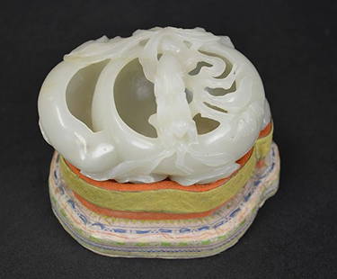 Chinese Carved White Jade Brushwasher & Stand: Chinese carved white jade brushwasher surrounded by a flower, topped with a mantis, and carved bat along the side. 3 1/2" x 3" x 1 3/4"