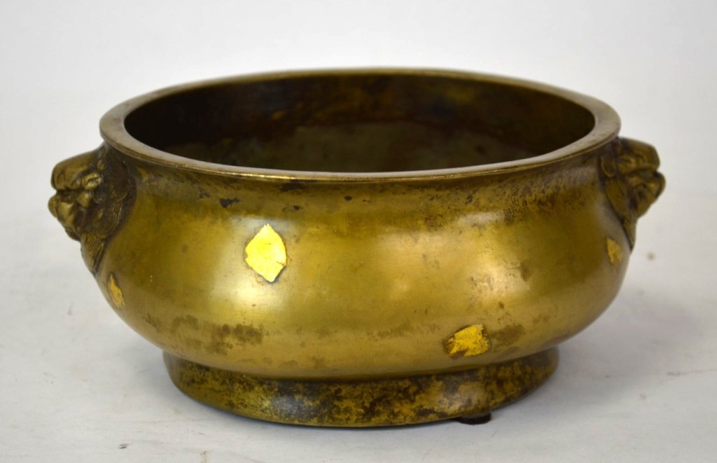 Chinese Bronze Incense Burner: Chinese bronze incense burner with two lion head handles, and two dragon figures. Chinese six character mark on bottom covered by gold. 7.25" x 3"