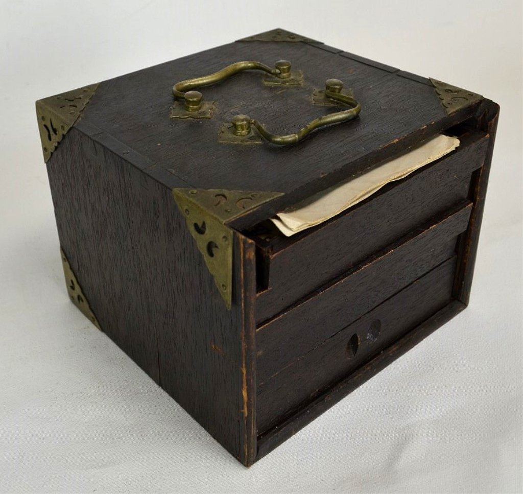 Mahjong Set in Wood Case: A complete Mahjong set with bone and bamboo pieces inside a wooden case with five drawers. Case is missing front insert. Includes original Hillson's Chinese Game instruction manual. Case measures 7 7/