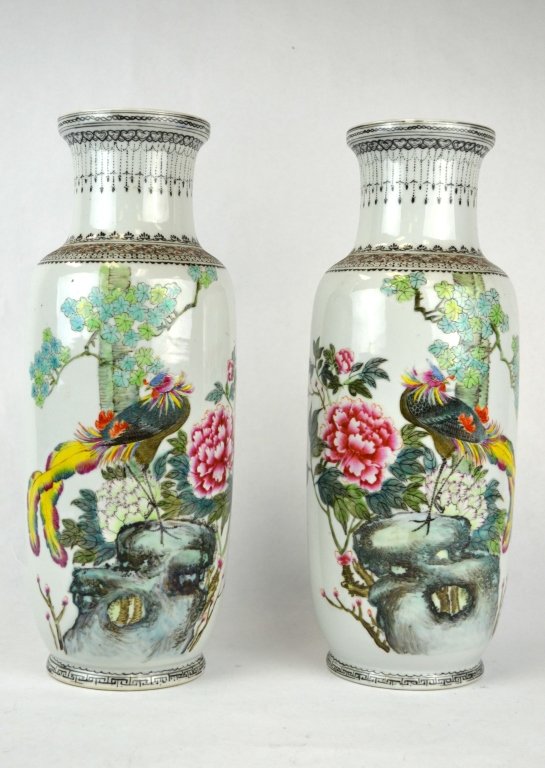 Pair of Tall Chinese Porcelain Famille Rose Vases: Pair of tall Chinese porcelain vases decorated in Famille Rose, each with a bird perched on rocks amongst flowering and leafy branches, the back with Chinese characters. Bottoms with drill hole throug