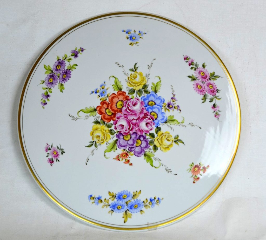 Dresden Porcelain Tabletop: A large porcelain tabletop decorated with hand painted flowers. Also a gold painted rim. Diameter - 18 1/8"