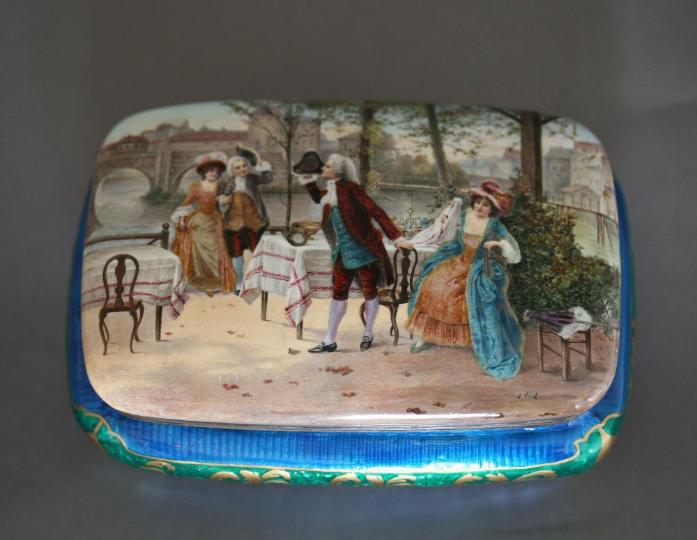A Limoges Enamel and Silver Box. 19th century. Painted : A Limoges Enamel and Silver Box. 19th century. Painted with figures in 18th century dress and highlighted in gilt on a blue and green ground. With silver gilt interior. Signed J Wat. 15.5 cm wide. 6.5