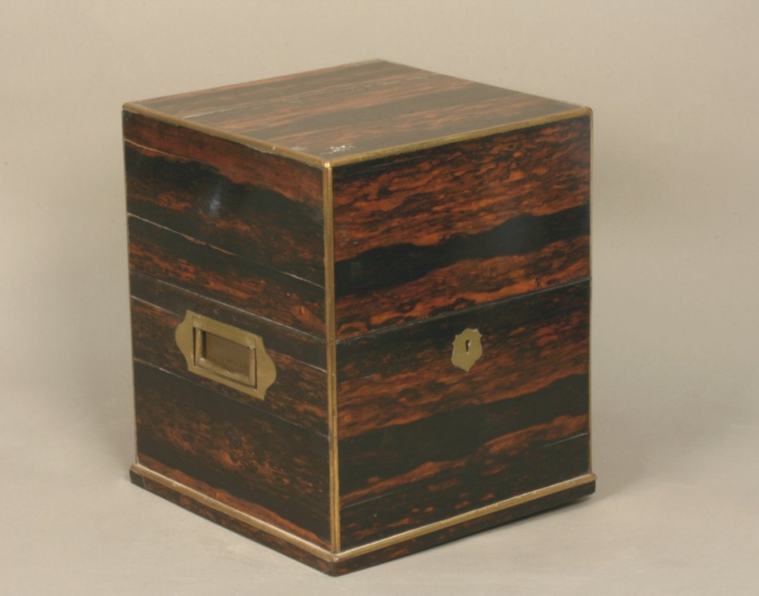 A good Calamander Wood Decanter Box. Mid 19th century: A good Calamander Wood Decanter Box. Mid 19th century. With twin flush gilt brass side handles, escutcheon and borders. The hinged cover opening to reveal a purple velvet lined fitted interior for fou