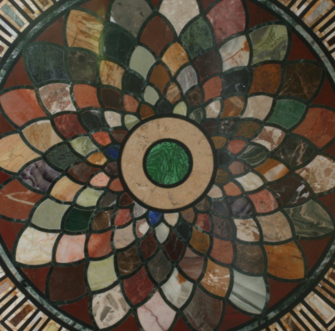 A Specimen Marble Table. Early 20th century: A Specimen Marble Table. Early 20th century. Of circular form. The black marble base inlaid with a central Malachite medallion and with a radiating leaf pattern of Lapis, Blue John, Sienna marble, Por
