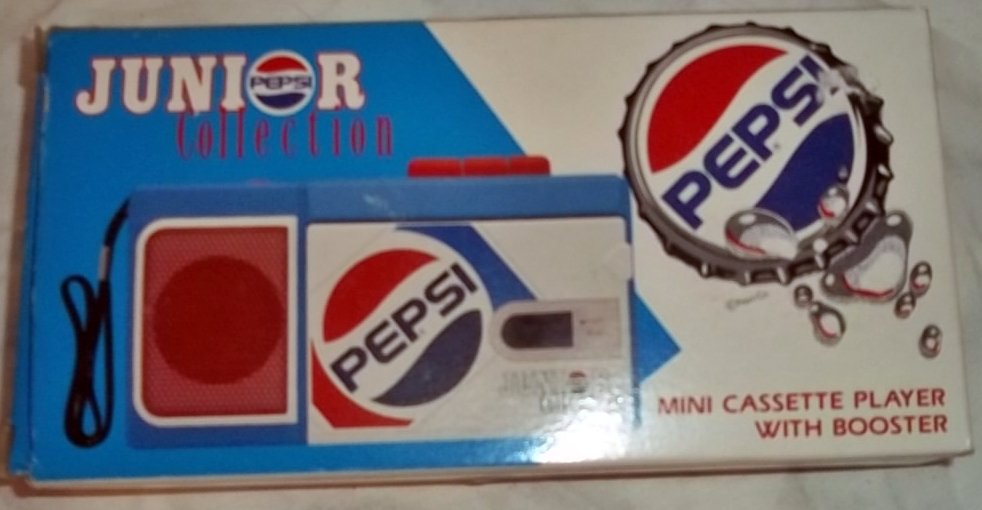Junior Pepsi Collection Mini Cassette player w/ booster: Junior Pepsi Collection mini cassette player with booster and headphone jack.Measures: 2-1/4” Speakers. Player – 3-1/2H X 7”L X 1-1/2”W