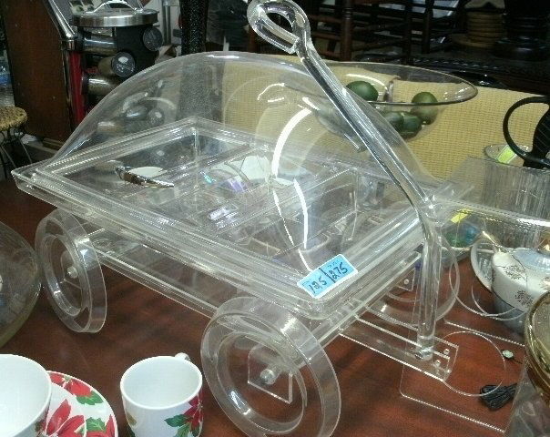 GENUINE LUCITE ART DECO CATERING WAGON!: Genuine Lucite Art Deco Catering Wagon. THIS IS A UNIQUE WAY TO SERVE COLD FOOD!COMES WITH REMOVABLE TRAY TO PUT ICE IN THE BOTTOM TO KEEP FOOD COLD!SLIDING TOP!WHEELS ROLL! DIMENSIONS: 23"L X 14-1/2"
