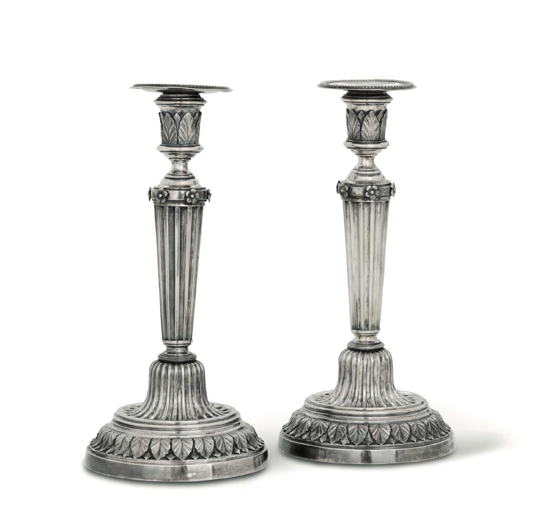 A pair of embossed and chiselled silver candlesticks, (1 of 2)