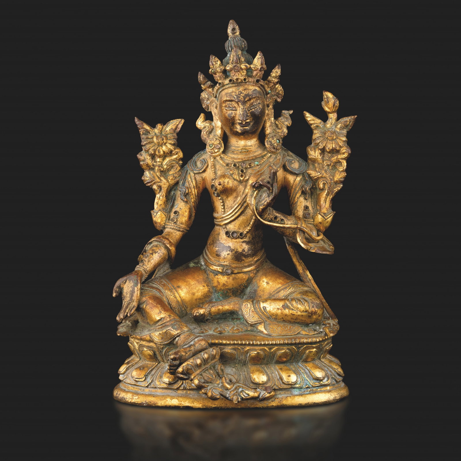 Gilt bronze Buddha figure seated on double lotus flower with gemstone inserts, Nepal, 17th century: .