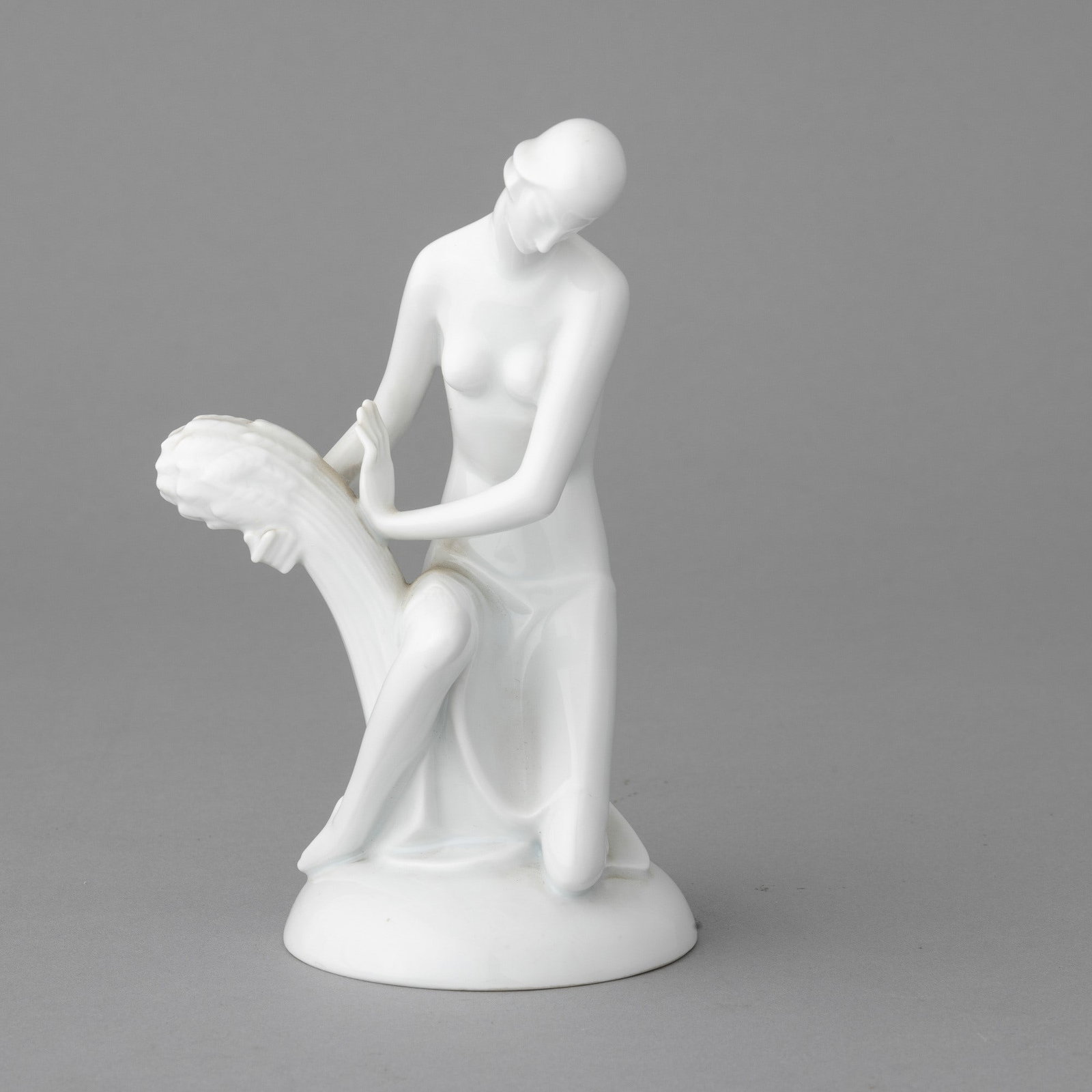 Gerhard Schliepstein 1886-1963 L'Estate Rosenthal, Germany 1930s: Porcelain statuette depicting a woman with a bunch of wheat on an oval base.Author's signature printed.