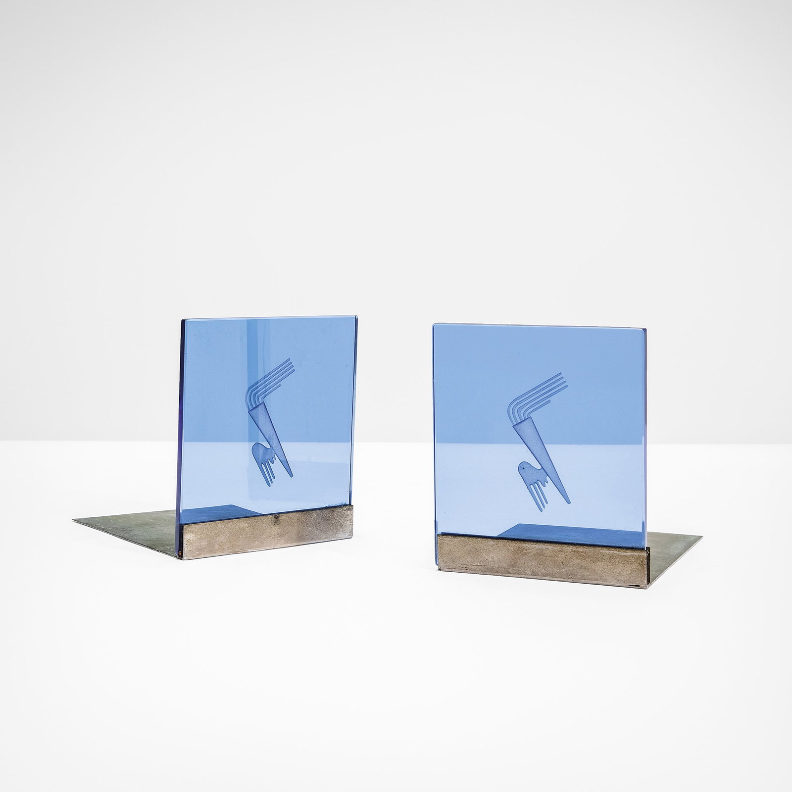 Gio Ponti Two bookends.: Engraved coloured beveled crystal and Nickel-plated brass structure.Fontana Arte, Italy, c. 1930.