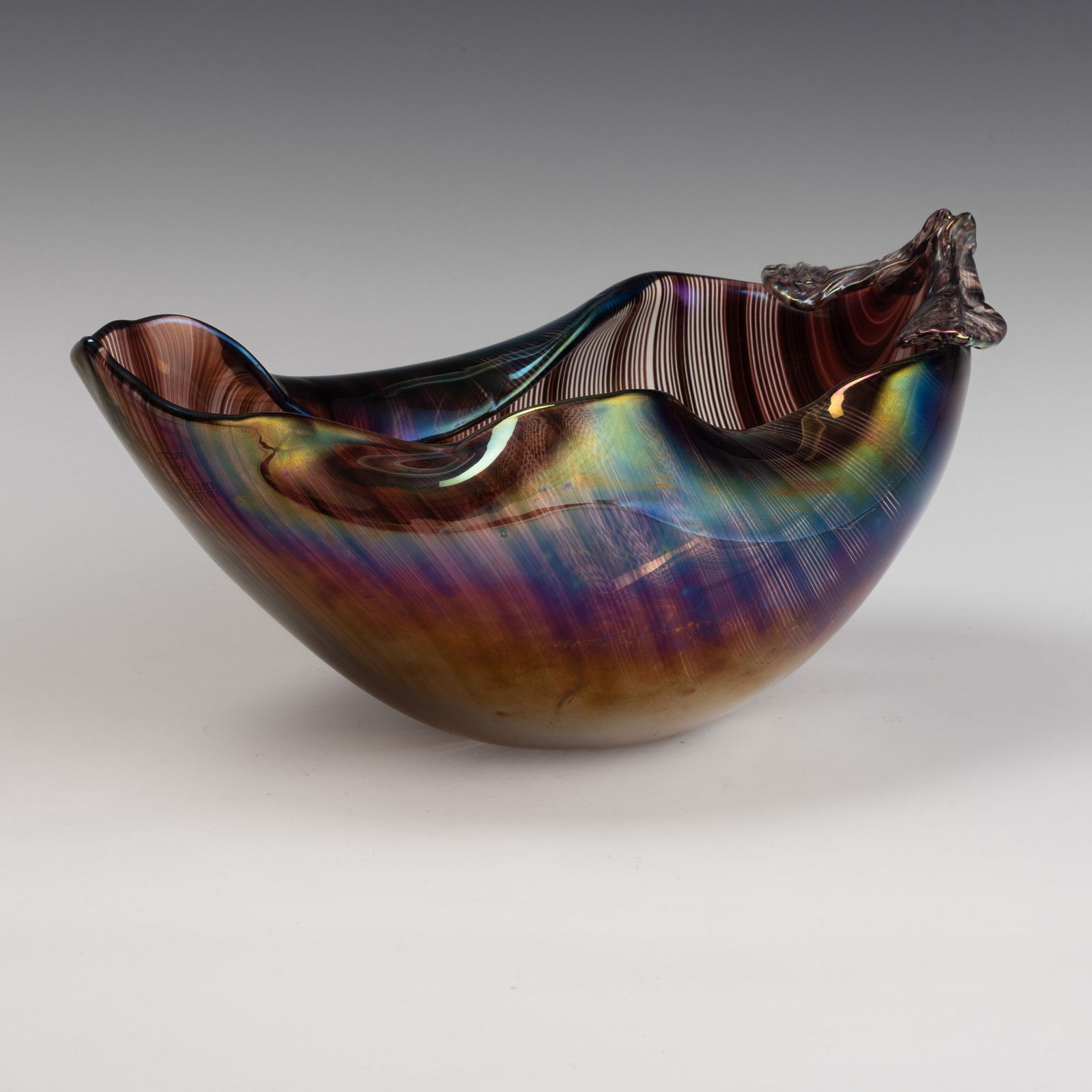 Tyra Lundgren 1897-1979 Venini, Murano, 1982.: Leaf-shaped ornament with undulating edge in half-filigree sommerso glass. Surface iridescent throughout. Etched signature, Venini Italia 1936, Tyra Lundgren 1982, and old labels.Restoration on one le