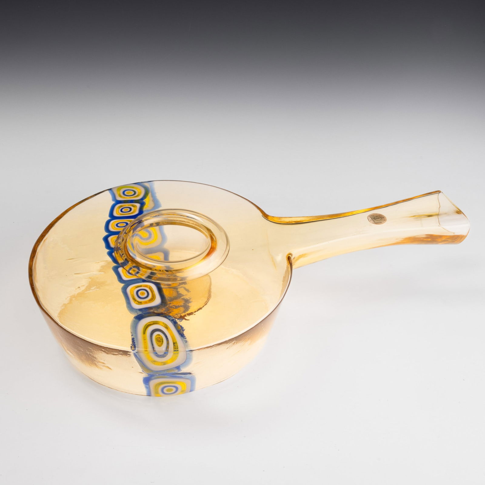 Gianmaria Potenza Nascita: 1936 La Murrina, Murano, 1960 ca.: Large centrepiece in the form of an oil lamp in moulded blown glass decorated with band of large murrines.Removable container.Old label. Cm 54 x 32,5 altezza cm 12,5