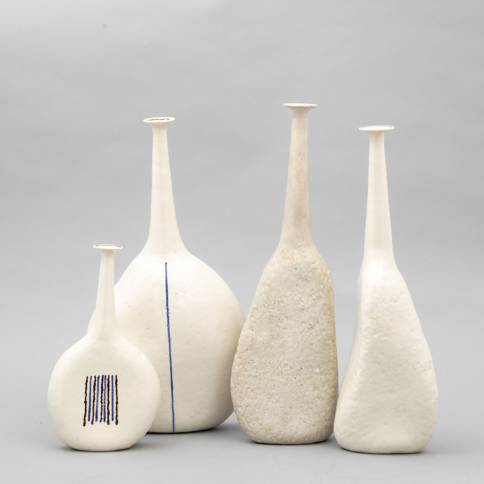 Bruno Gambone 1936-2021 B. Gambone, Florence 1970 ca: Four solifleur enamelled grès vases with a polychrome decor. Manufacturer's mark, altezze cm 24, 38 e 40