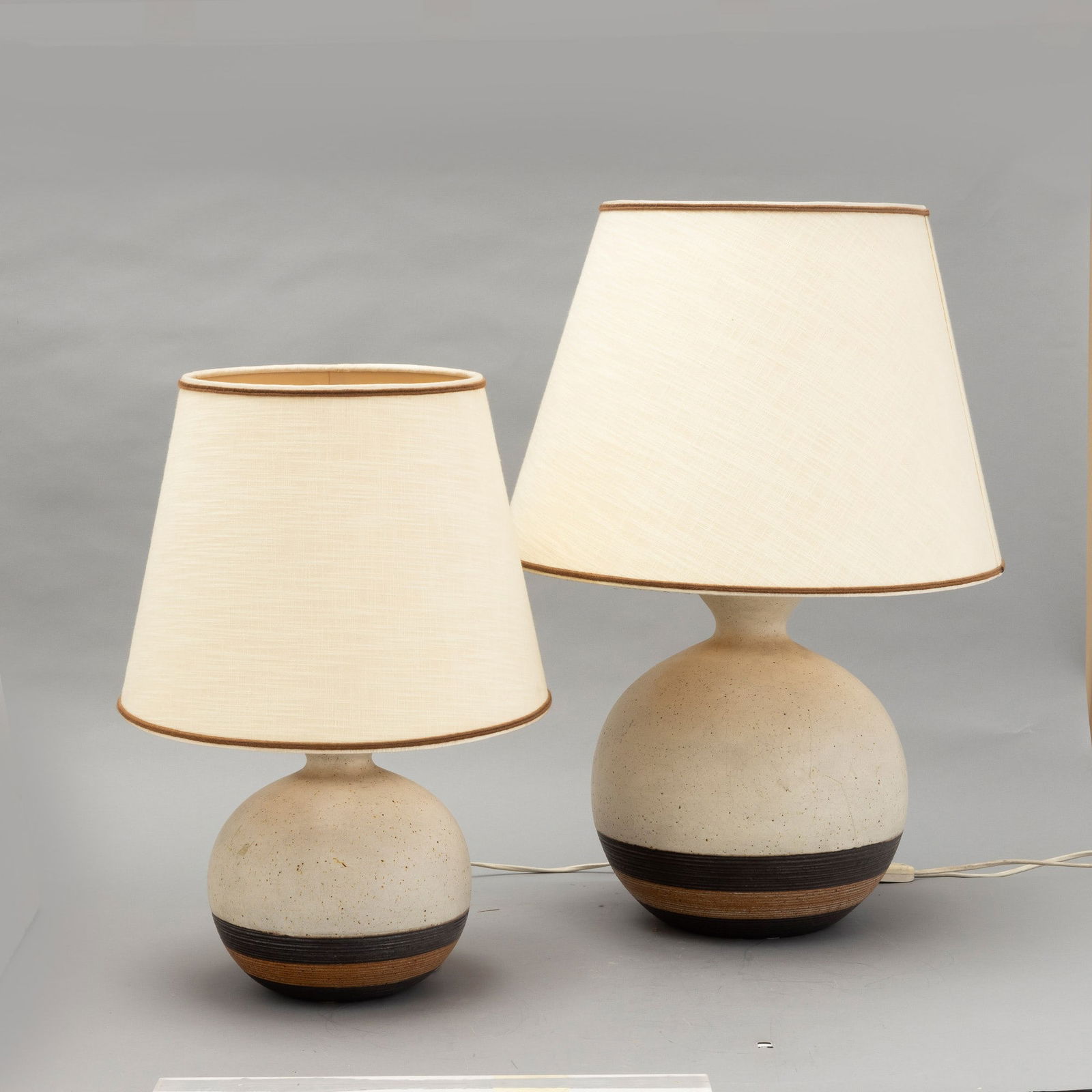 Bruno Gambone 1936-2021 B. Gambone, Florence 1970 ca: Two grès lamp bases with a polychrome decor on the lower part. Author's signature, altezza cm 20,5 e 30