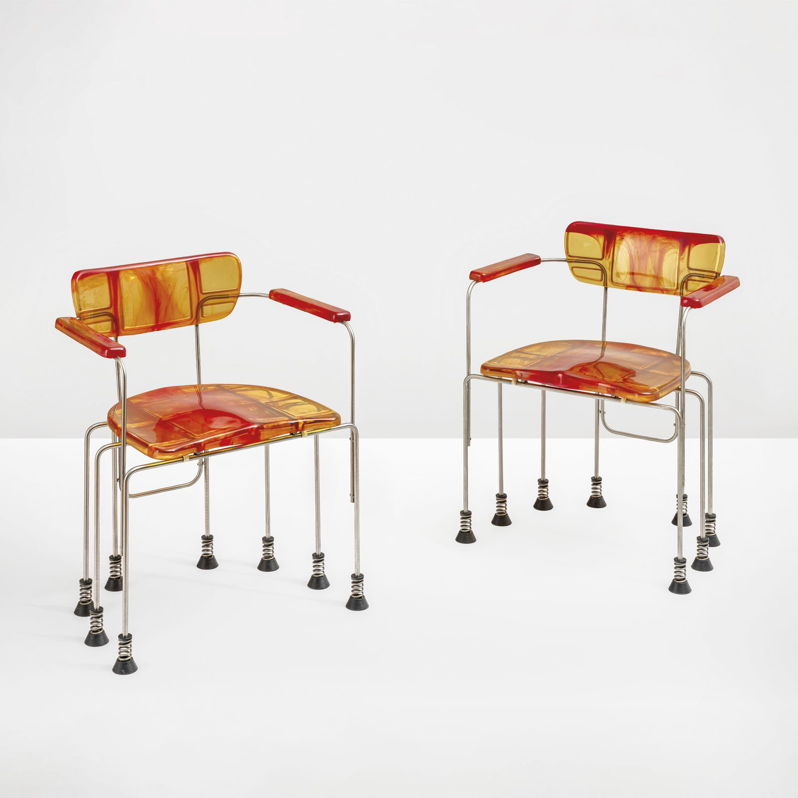 Gaetano Pesce Two mod. 544 Broadway armchairs.: Chromed steel structure with epoxy resin seat. Suspended feet on springs with rubber base. Bernini, Italy, 1993 Production catalogue.