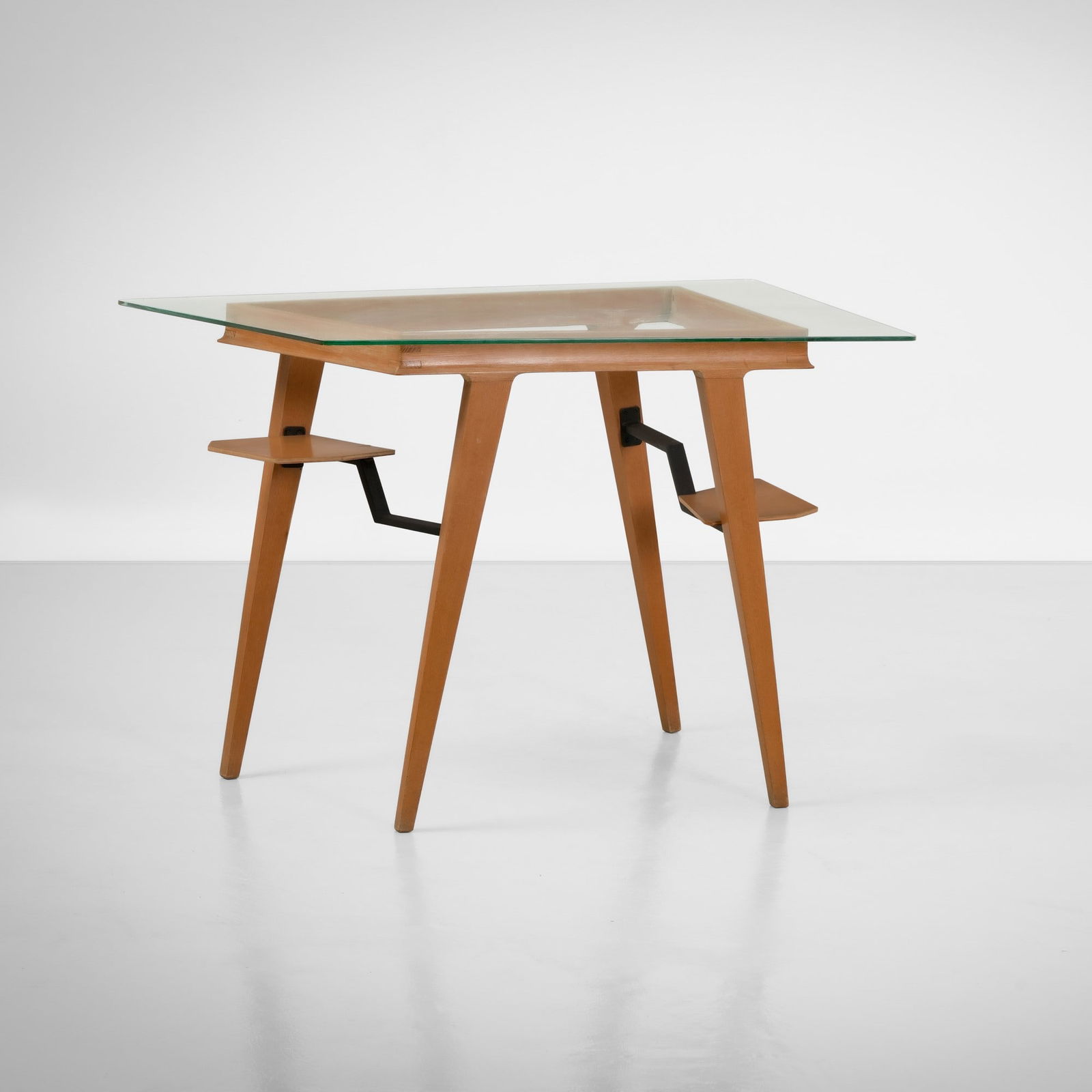 Melchiorre Bega , attribuito a Tavolo: Struttura in legno, dettagli in metallo e piano in cristallo colorato. Prod. Italia, 1950 ca.