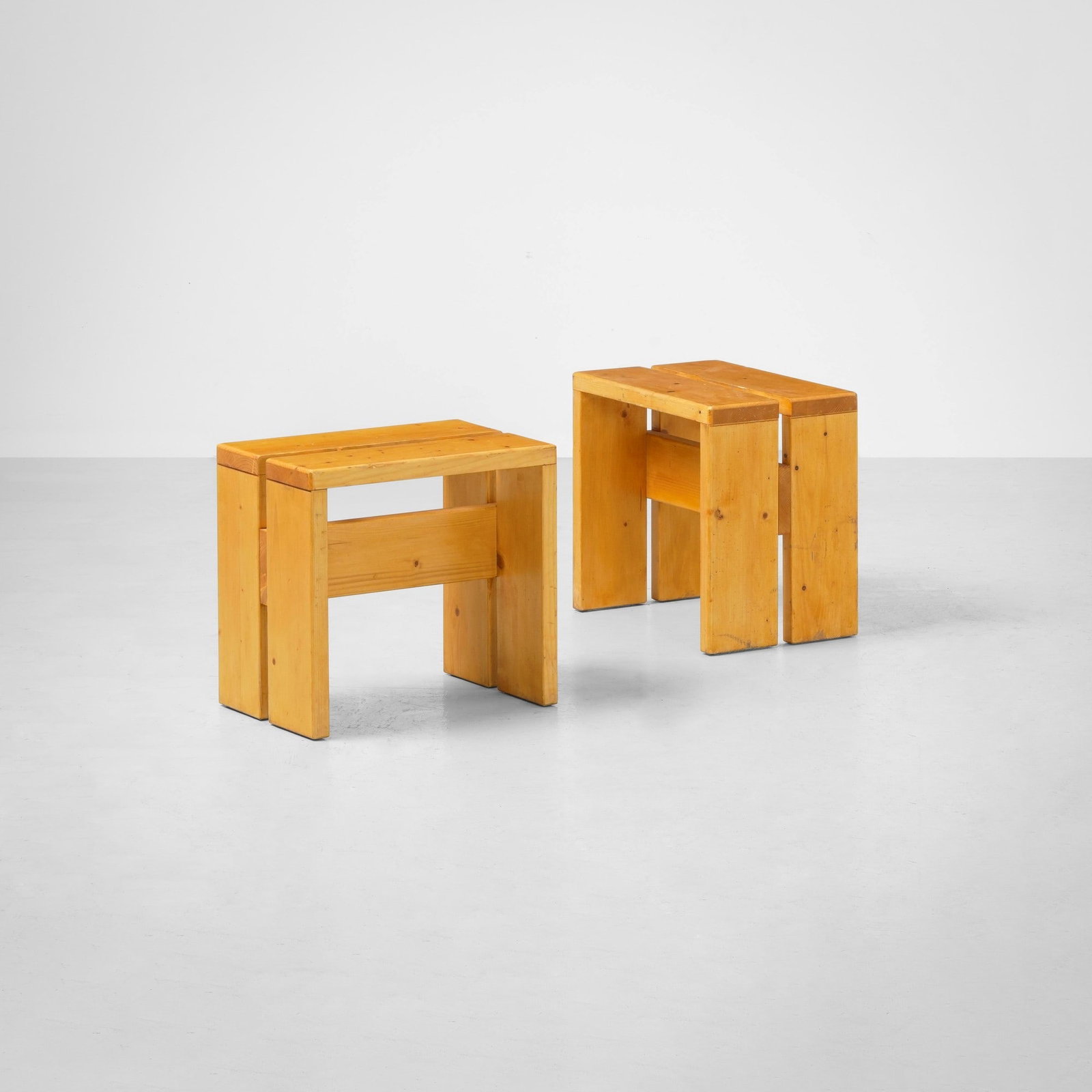 Charlotte Perriand , attribuito a Due sgabelli mod. Les Arcs: Struttura in legno. Prod. Francia, 1960 ca.