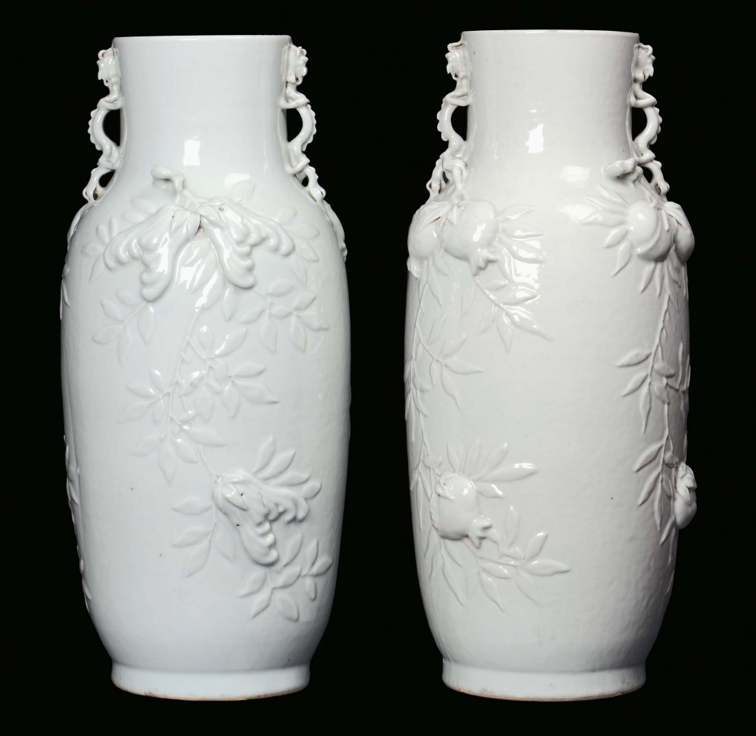 A pair of Blanc de Chine porcelain vases decorated with