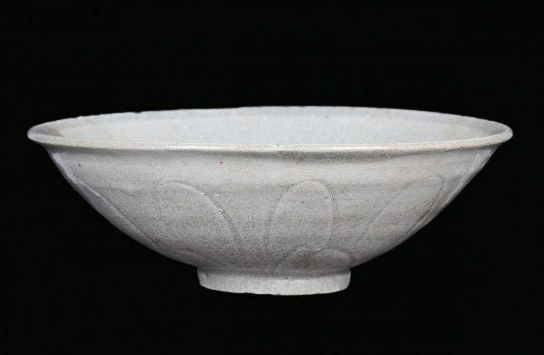A white engraved earthenware Qingbai bowl decorated wit