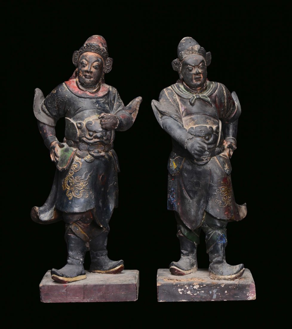 A pair of large black lacquered earthenware Dignitaries