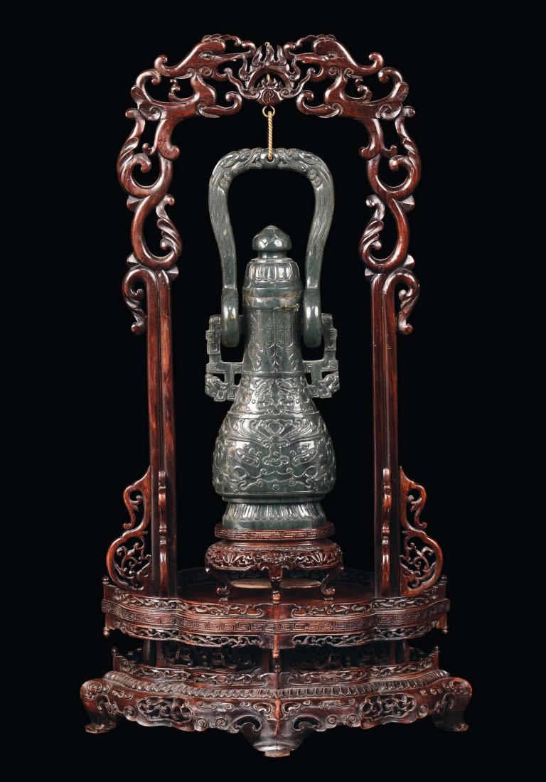 A spinach green jade vase with wooden base carved with 