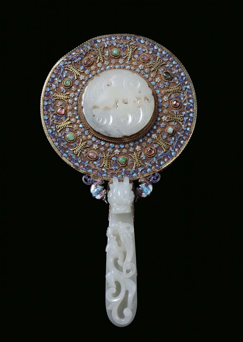 A small mirror with gilt silver frames with enamels and