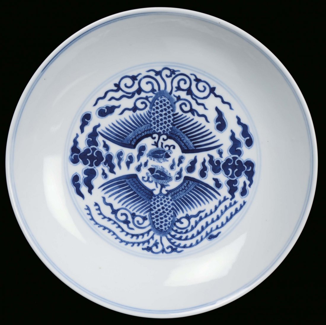 A white and blue porcelain plate decorated with phoenix