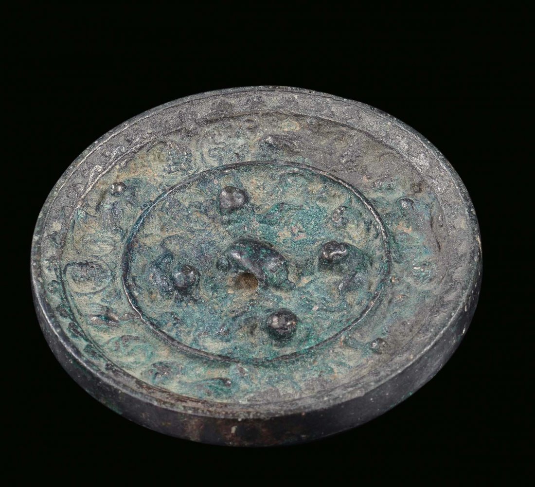 A silver-plated bronze mirror, China, Han Dynasty, 2nd 