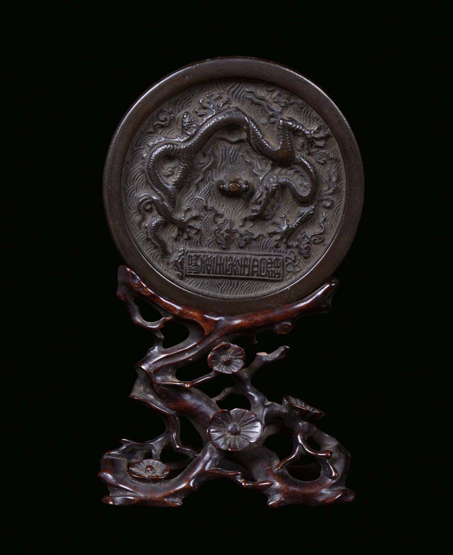 A silver plated bronze mirror with carved wood base, Ch