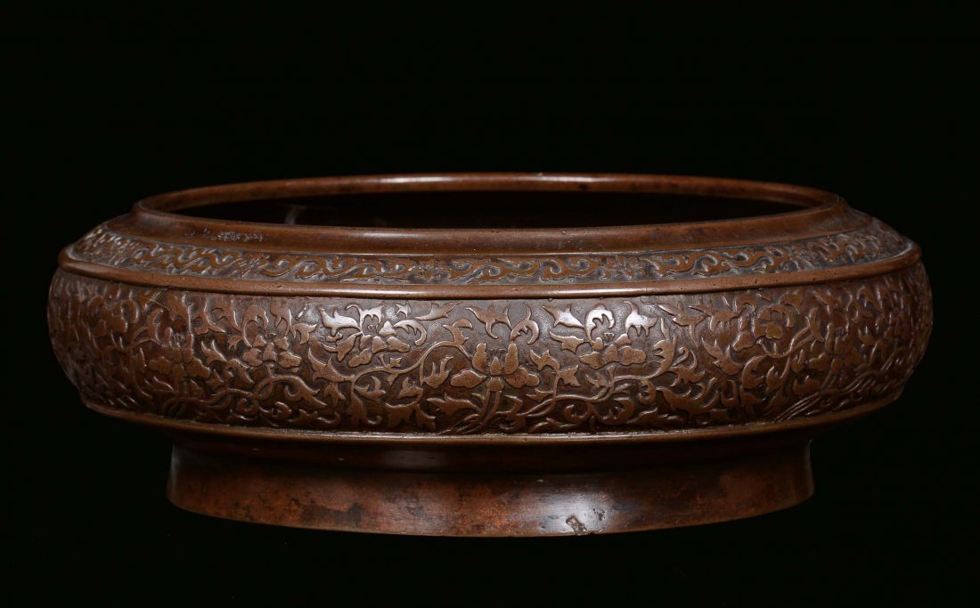A bronze censer with relief band decorated with vegetab