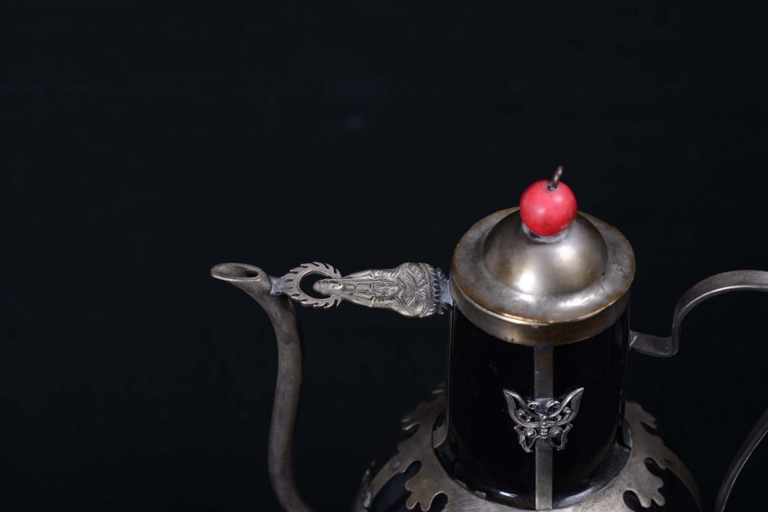 A small glass and metal teapot decorated with figures a - 2