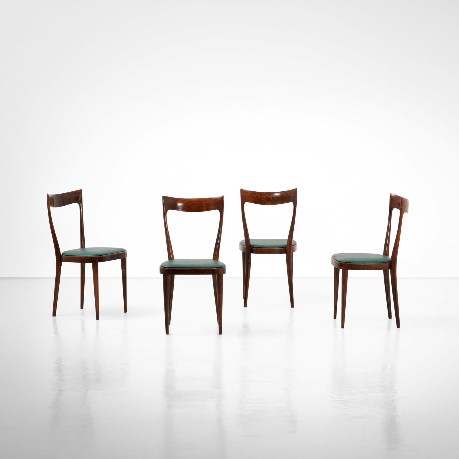 Quattro sedie: Struttura in legno e rivestimento in skai. Prod. Italia, 1960 ca. . Measuers: cm 44X48X88