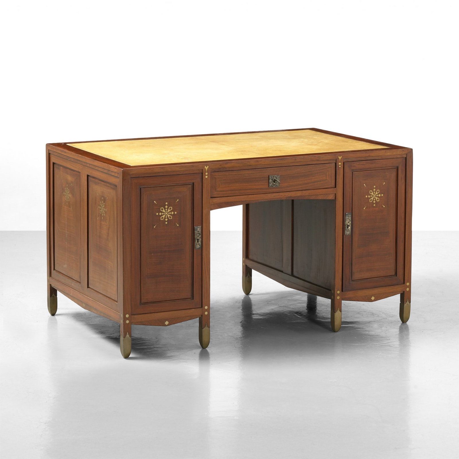 Piero Zen Scrivania: Struttura in legno e legno impiallacciato a decoro intarsiato. Piano rivestito in pergamena. Puntali e serrature in ottone. Etichetta originale. Prod. Italia, 1900 ca. . Measuers: cm 140X90X80