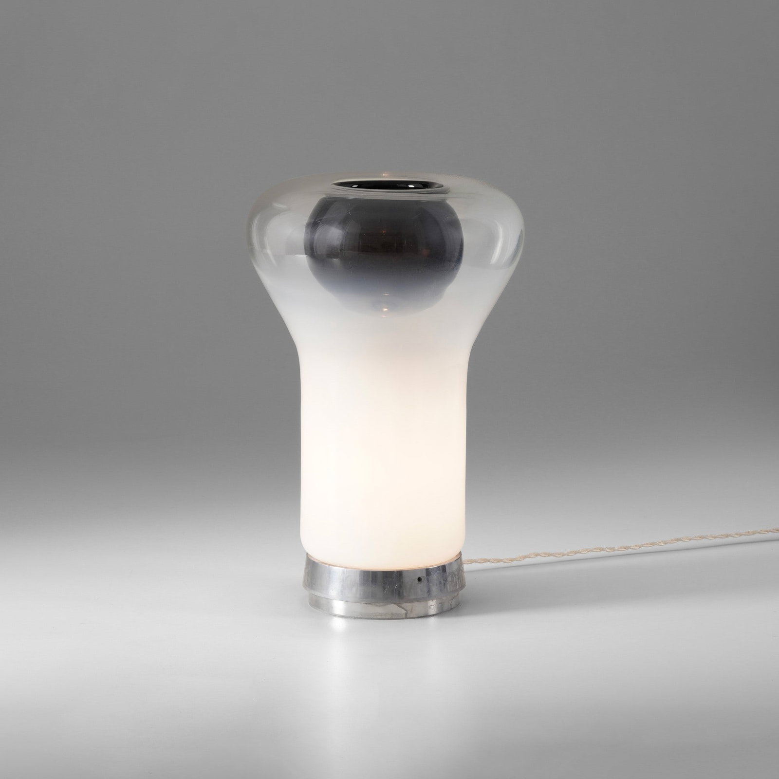Angelo Mangiarotti Lampada da tavolo mod. Saffo: Struttura in alluminio pressato e diffusore in vetro. Prod. Artemide, Italia, 1967. G. Gramigna, Repertorio del design italiano 1950-2000, p. 140, Allemandi, 2021 . Measuers: W. 25 - H. 32 cm