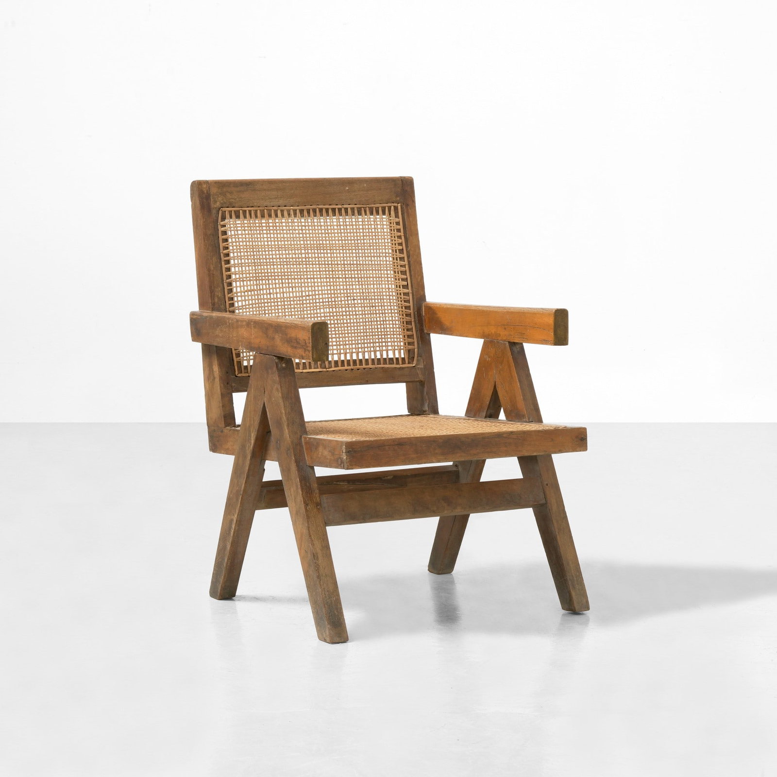 Pierre Jeanneret Poltrona: Struttura in legno con seduta e schienale in canna intrecciata. Prod. India, 1960 ca. . Measuers: cm 56X60X80