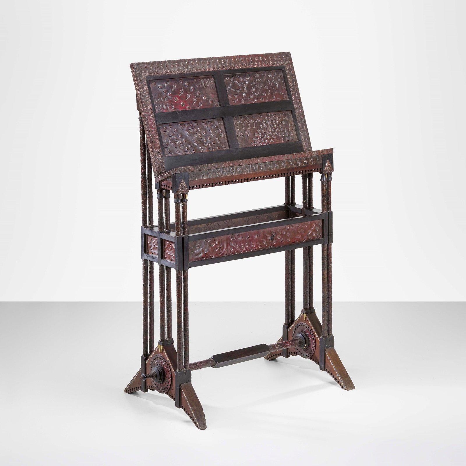 Carlo Bugatti Lectern: Structure in wood and ebonized wood. Applications in metal, embossed copper and bone. From a private collection - Milan. Bugatti, Italy, c. 1900. . Measuers: W. 100 - D. 56 - H. 136 cm