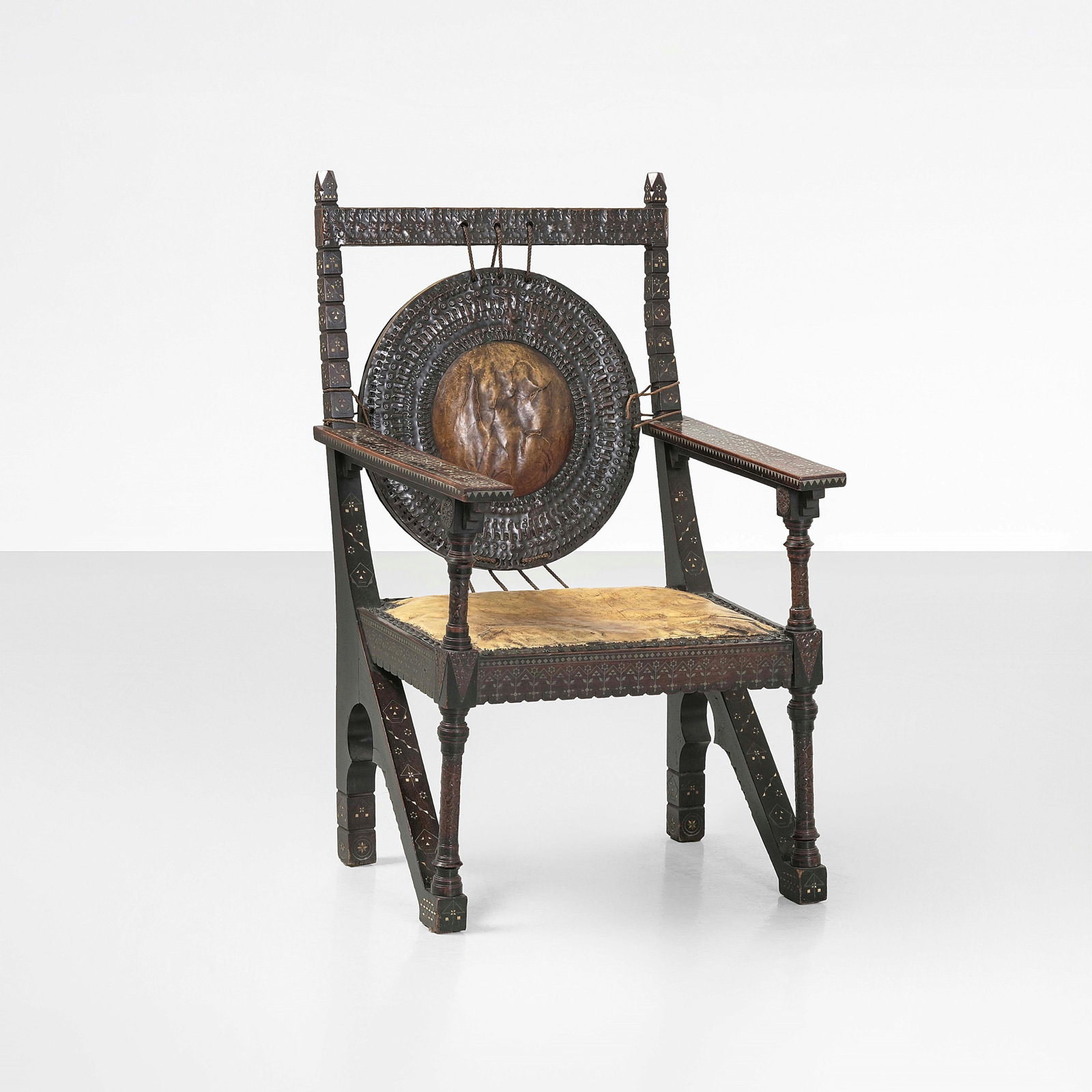 Carlo Bugatti Armchair: Structure in wood, ebonized wood, metal inlays, copper elements and parchment covering. Bugatti, Italy, 1900. P. Dejean, Carlo-Rembrandt-Ettore-Jean Bugatti, p. 82, Automobilia, 1982 . Measuers: cm