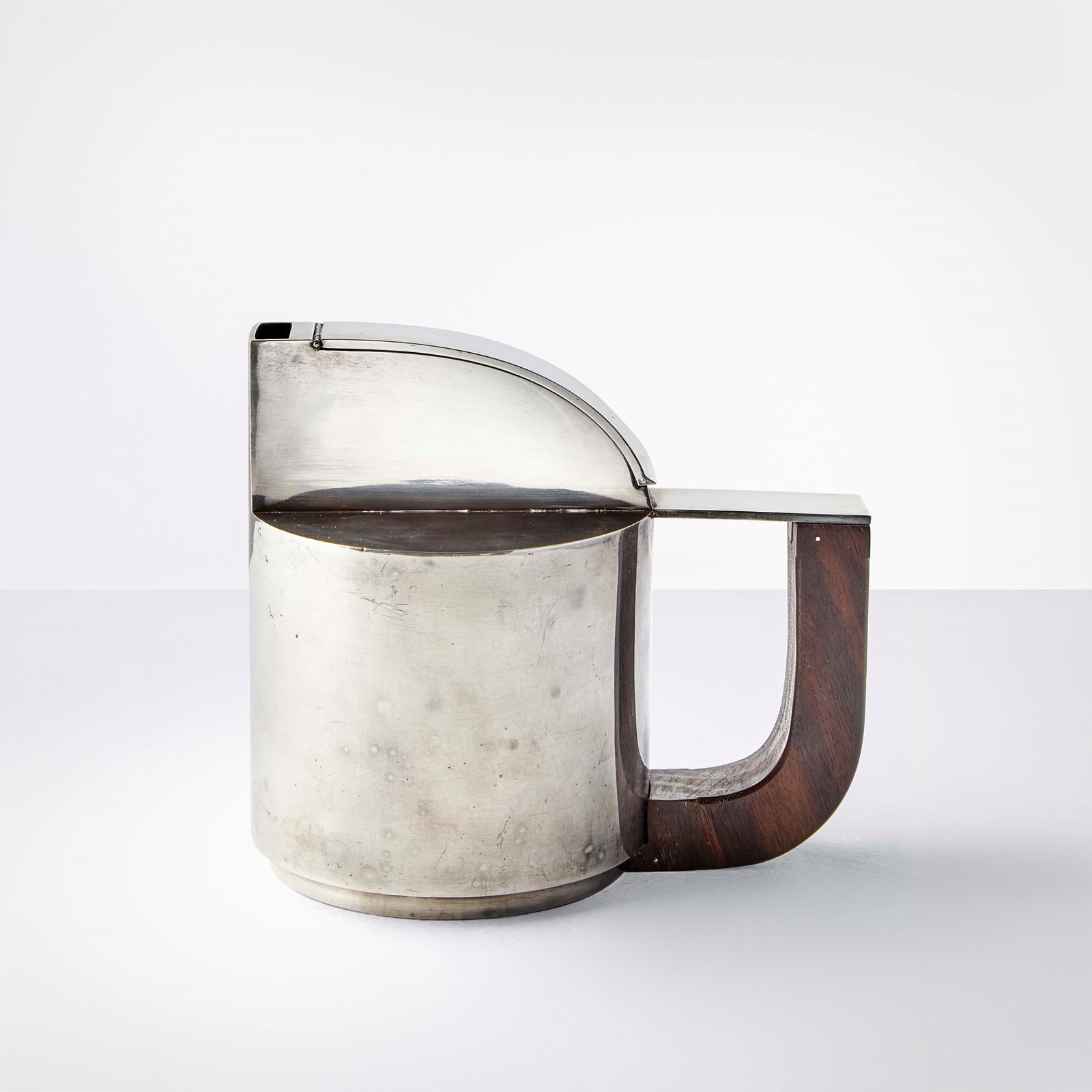G?rard Sandoz Rare teapot: Silver-plated metal and wood. Manufacturer's mark. Original design for the 1926 Paris Salon d'Automne. Prod. Sandoz & Orf?vres, France, c. 1920. Mobilier et D?coration, p. 160, dicembre 1926. .